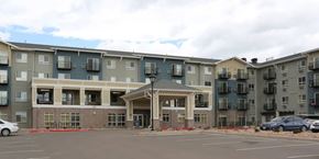 Colorado Springs apartment for rent - A large apartment complex with a parking lot in front.