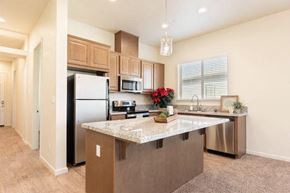 Modesto apartment for rent - a kitchen with a large island and stainless steel appliances