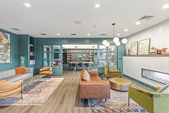 A living room with a grey sofa and a green armchair.