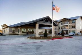 Kerrville apartment for rent - A building with a flag on top of it.