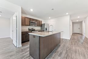 Ocean Springs apartment for rent - Modern kitchen with granite countertops, stainless steel appliances, and wood-look flooring.