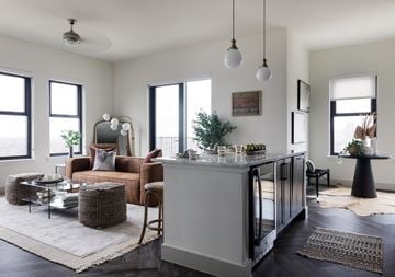 Dallas apartment for rent - A modern living room with a brown chair and a grey cabinet.