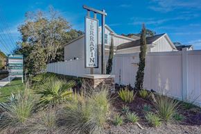 Jacksonville townhouse for rent - Terrapin Station single-family home rentals entrance sign with white fence and landscaping.