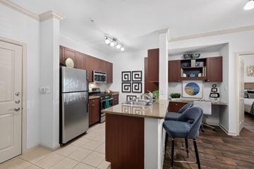 Woodbridge apartment for rent - A kitchen with a refrigerator, cabinets, and a counter.