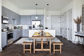 Dallas apartment for rent - A modern kitchen with a dining table set for two.