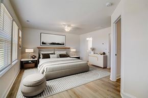 Sherrills Ford townhouse for rent - Sherrills Ford, NC, Townhomes Near Charlotte Douglas International Airport - Montera at Sherrills Ford - A Bedroom with Wide Windows, Ceiling Fan, and Light Wood Flooring.