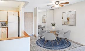 Coon Rapids apartment for rent - A modern dining room with a white table and chairs.