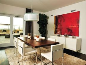 Irvine apartment for rent - A modern dining room with a wooden table and white chairs.
