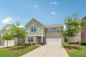 Locust Grove apartment for rent - A house with a garage and a driveway in front.