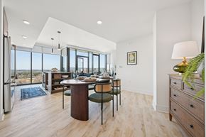 Raleigh apartment for rent - A modern dining room with a wooden table and chairs.