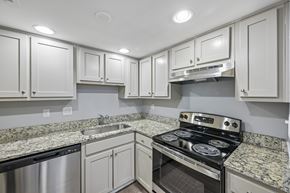 Raleigh apartment for rent - A kitchen with granite countertops and stainless steel appliances.