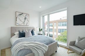 Philadelphia apartment for rent - A bedroom with a large bed and a chair.