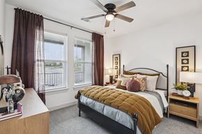Celina apartment for rent - A bedroom with a bed, nightstand, and window with curtains.