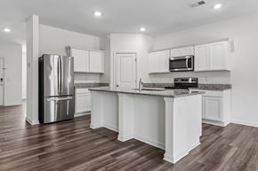 Locust Grove apartment for rent - A kitchen with white cabinets and a stainless steel refrigerator.