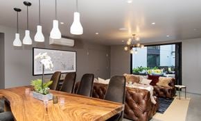 Oakland apartment for rent - A modern dining room with a wooden table and brown leather chairs.