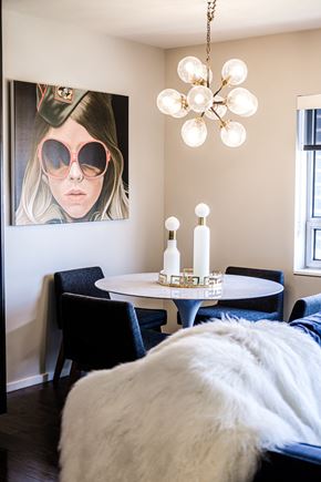 Dallas apartment for rent - a bedroom with a bed and a table and a picture of a woman wearing sunglasses