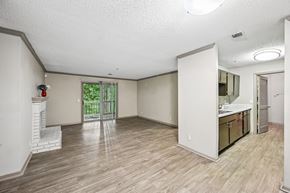 Austell apartment for rent - A spacious room with light wood flooring and white walls.