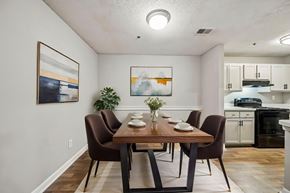 Duluth apartment for rent - A dining room with a wooden table and brown chairs.