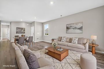 Myrtle Beach triplex for rent - A living room with a grey couch, a coffee table, and a painting on the wall.