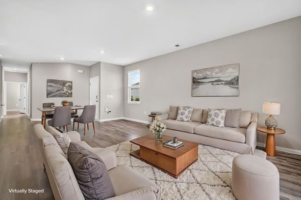 Myrtle Beach triplex for rent - A living room with a grey couch, a coffee table, and a painting on the wall.