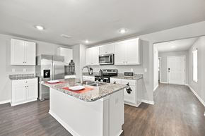 Foley apartment for rent - A kitchen with white cabinets and a granite countertop.