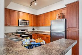 Phoenix apartment for rent - A kitchen with wooden cabinets and a granite countertop.