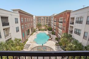Houston apartment for rent - A view of a pool from a balcony of a building.