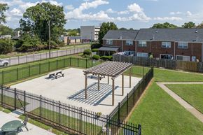 Newport News apartment for rent - A black fence surrounds a playground with a wooden structure.