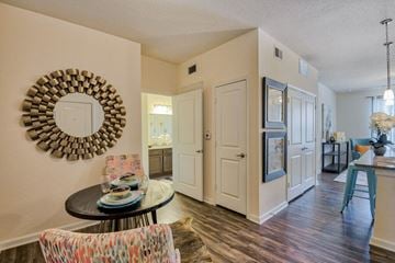 Tallahassee apartment for rent - a living room and kitchen with a table and a mirror