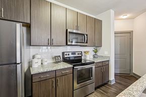 Odessa apartment for rent - A kitchen with wooden cabinets and stainless steel appliances.