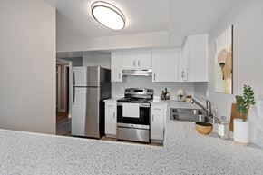 Colton apartment for rent - One-Bedroom Apartments in Colton, CA - Ardella at Reche Canyon - Kitchen Features White Cabinets, Stainless Steel Refrigerator And Stove, Speckled Countertops, And A Double Sink.
