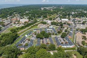 Newport News apartment for rent - A bird's eye view of a large parking lot surrounded by buildings and trees.