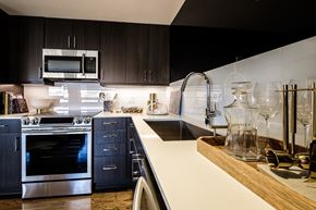 Dallas apartment for rent - a kitchen with stainless steel appliances and white counter tops