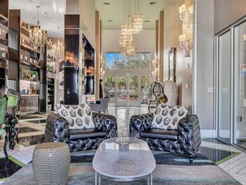 Henderson apartment for rent - A living room with black leather sofas and a glass table.