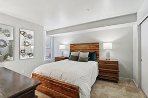 Las Vegas apartment for rent - A bedroom with a bed, nightstand, and wall art.