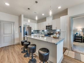 Saginaw apartment for rent - Saginaw, TX Luxury Apartments with In-Unit Washer and Dryer - Grand at Saginaw - Kitchen with Granite Countertops, Stunning White Cabinetry, and Modern Appliances
