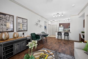Woodbridge apartment for rent - A living room with a green chair and a coffee table.