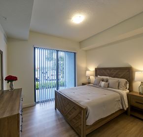 Pompano Beach apartment for rent - Spacious bedroom at Gateway Luxury Apartments in Pompano Beach, featuring large sliding glass doors that brings in abundant natural light.