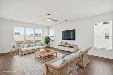Fountain Inn townhouse for rent - A living room with a white ceiling and a television on the wall.