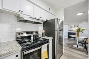 Phoenix apartment for rent - A modern kitchen with a black stove top oven and a black refrigerator.