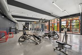 Tempe apartment for rent - A gym with a variety of equipment including a leg press machine.