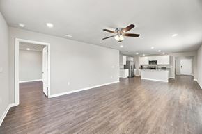 Foley apartment for rent - A spacious room with a ceiling fan and hardwood floors.