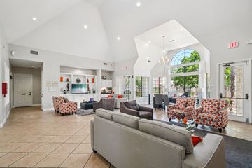 San Antonio apartment for rent - A spacious living room with a grey sofa and a chandelier.