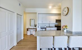 Pompano Beach apartment for rent - Modern kitchen at Gateway Luxury Apartments in Pompano Beach, featuring premium stainless-steel appliances, granite countertops, and a chef-inspired island.
