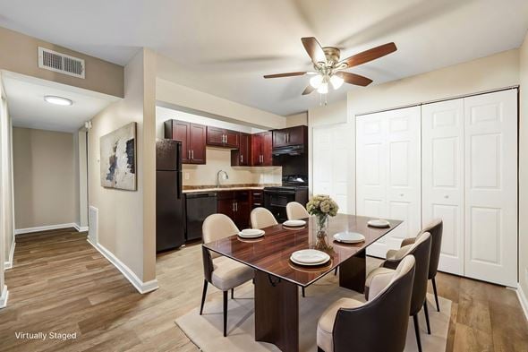 Charlotte apartment for rent - A dining room with a table set for two and a kitchen in the background.
