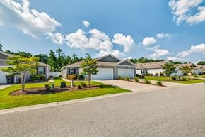 Myrtle Beach triplex for rent - A residential area with houses and trees.