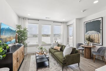 Celina apartment for rent - A living room with a green couch, a coffee table, and a painting on the wall.