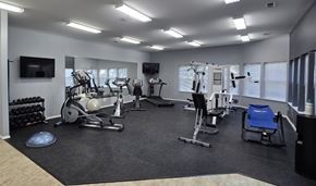 Coeur D Alene apartment for rent - a gym with cardio equipment and a tv in a building