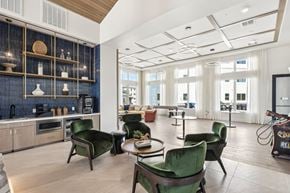 Henderson apartment for rent - A modern kitchen with green chairs and a blue backsplash.