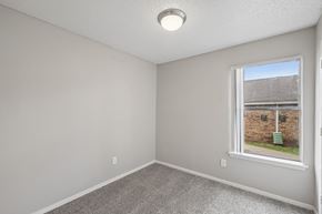 Fort Worth apartment for rent - A room with a window showing a view of a building and a green post.